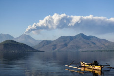Mount Lewotobi Laki-Laki spews ash and smoke during an eruption as seen from Lewolaga village in Titihena, East Nusa Tenggara, on November 13, 2024.