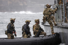 Personnel from the Defense Forces of Australia, Japan, South Korea and the United States, plus officers from the Australian Federal Police and New South Wales Police Force, participate in a boarding exercise as part of training activities for Exercise Pacific Protector 2024, at Sydney Harbor in Sydney on September 26, 2024. 