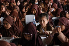 Fueling up: Students eat free meals on Nov. 12, 2024 during a school lunch program organized by the naval command in Makassar, South Sulawesi. 

