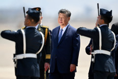 China's President Xi Jinping (C) revies a guard of honor upon his arrival for the Asia-Pacific Economic Cooperation (APEC) Summit at Air Force Base 8, annexed to the Jorge Chavez International Airport, in Callao, Peru, on November 14, 2024.
