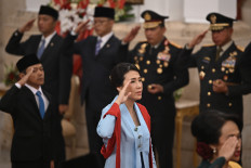 Deputy Women's Empowerment and Children’s Protection Minister Veronica Tan sings the national anthem 'Indonesia Raya' after the swearing-in of President Prabowo Subianto’s Red and White Cabinet in the State Palace on Oct. 21, 2024. 