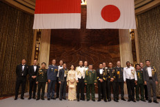 Anniversary celebration: Japanese Defense Attache Capt. (Navy) Hamakawa  Sho (center right) and wife Hamakawa Mai (center left) pose with defense attaches from other countries during a diplomatic reception to celebrate the 70th anniversary of the Japan Self-Defense Force Commemoration Day in Jakarta on Nov. 12. Japanese ambassador to Jakarta Masaki Yasushi said that Japan was committed to strengthening defense cooperation with Indonesia. 
