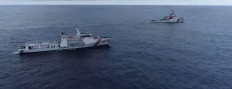 Maritime Security Agency (Bakamla) patrol vessel KN Pulau Dana (foreground) shadows China Coast Guard (CCG) patrol vessel 5402 on Oct. 25, 2024, in the North Natuna Sea, which falls within Indonesia’s exclusive economic zone (EEZ).