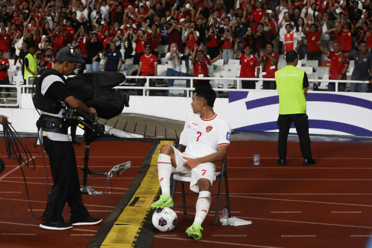 Indonesian national soccer team player Marselino Ferdinan celebrates his second goal for Indonesia by sitting on the official's chair during the 2026 World Cup Asian third round qualifier matcha against Saudi Arabia at the Gelora Bung Karno Main Stadium in Jakarta on Nov. 19, 2024. Indonesia won 2-0 over Saudi.