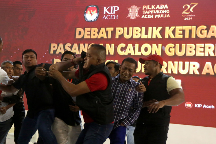 Supporters of gubernatorial candidate pairs Bustami Hamzah-M. Fadhil Rahmi and Muzair Mana-Fadhullah fight on stage on November 19, 2024 during the third election debate for the Aceh governorship election in Aceh Besar regency, Aceh. The debate was interrupted due to the fight.