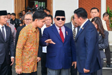 This handout picture taken and released on November 8, 2024 by the Presidential Palace shows President Prabowo Subianto (center) speaking with Vice President Gibran Rakabuming Raka (2nd left) and the Coordinating Minister for Political and Security Affairs Budi Gunawan (right) at Halim Perdanakusuma Air Base in Jakarta. 