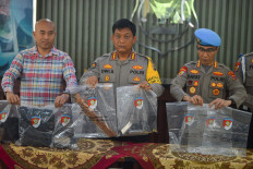 West Sumatra Police spokesperson Sr. Comr. Dwi Sulistyawan (center), general crimes director Sr. Comr Andri Kurniawan (left) and internal affairs division chief Sr. Comr. Hidayat (right) show evidence from the shooting of South Solok Police chief detective Adj. Comr. Ryanto Ulil Anshari, on Nov. 23, 2024, during a press briefing at the police headquarters in Padang. The police named South Solok Police operations chief Adj. Comr. Dadang Iskandar a suspect in the case.