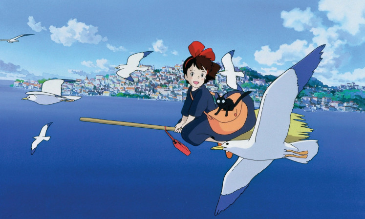 The young witch, Kiki, soars through the skies after delivering packages across the city.