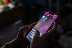 A teenager uses a smartphone to access social media on Jan. 31, 2024, in New York City, the United States.
