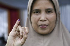 Exercising her right: A voter shows her inked finger after voting at a polling station in Bogor regency, West Java, on Nov. 27. The General Elections Commission (KPU) aims for an 82 percent voter turnout in the 2024 simultaneous regional elections.