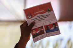 A local poll administrator shows an invalid ballot on Nov. 27, 2024, during the tabulation of votes cast in the 2024 Central Java gubernatorial election at a polling station in Semarang, Central Java.