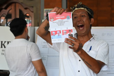 A poll administrator counts votes for the Denpasar mayoral election on Nov. 27, 2024, at a polling station in Denpasar, Bali.