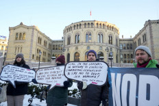 Protesters hold placards during a demonstration against seabed mining outside the Norwegian Parliament building in Oslo on Jan. 9, 2024. Norway's parliament voted on January 9, 2024 on a bill on opening up parts of its seabed to mining, spurring protests from environmental activists worried about the impact.
