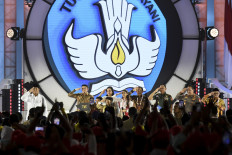 President Prabowo Subianto (left) salutes teachers on Nov. 28, 2024, during a National Teacher's Day commemoration event in Jakarta. Also attending the event were (from right to left) Elementary and Secondary Education Minister Abdul Mu'ti, National Police chief Gen. Listyo Sigit Prabowo, Indonesian Military (TNI) commander Gen. Agus Subiyanto, Home Minister Tito Karnavian, Finance Minister Sri Mulyani Indrawati and Cabinet Secretary Teddy indra Wijaya.