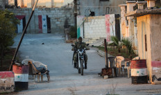 A rebel led by the Islamist militant group Hayat Tahrir al-Sham drives on a motorbike at a checkpoint in al-Rashideen, Aleppo province, Syria on Nov. 29, 2024.