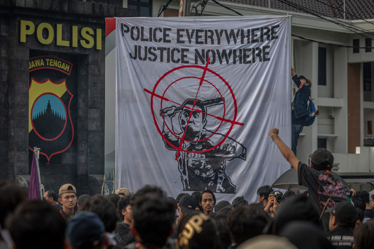 Protesters hold a demonstration in front of the Central Java Police headquarters in Semarang on Nov. 28, 2024. They demanded a complete and transparent investigation into the shooting by a police officer of a 17-year-old high school student in the city on Nov. 24.