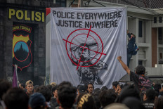 People take part in a demonstration call on Nov. 28, 2024, in front of the Central Java Police headquarters in Semarang, demanding a complete and transparent investigation into the fatal police shooting of a 17-year-old senior high school student on Nov. 24 in the provincial capital.