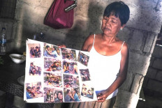 Celia Veloso, the mother of Mary Jane Veloso, a Filipina on death row in Indonesia, shows off family pictures to BenarNews at her home in Cabanatuan city, north of Manila, Nov. 26, 2024.