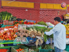 A person sells food on a market square in Bogota, Colombia, on Dec. 1, 2024.