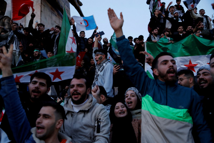 Syrians living in Turkey celebrate after Syrian rebels announced that they had ousted President Bashar al-Assad in Syria, in Istanbul, Turkey, on Dec. 8, 2024. 