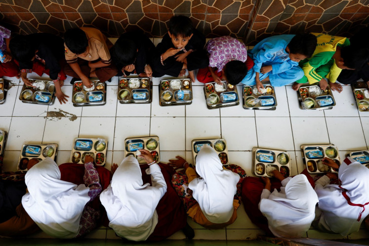 Students eat their meals during a free nutritious meal program trial during their break time at their school in Sukabumi, West Java, on Sept. 26, 2024. 