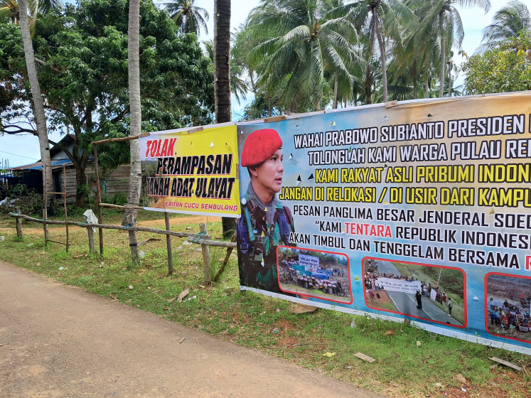 Protest signs are pictured on Dec. 5, 2024, on the outskirts of Sembulang village on Rempang Island, where a glass and solar panel manufacturing site is to be constructed. Set up by a group of villagers resisting eviction for the industrial project, the signs reads: &ldquo;To those who have accepted relocation: You are strictly prohibited from coming back to Sembulang!!!&rdquo;.
