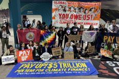 Activists hold a silent protest on Nov. 16 inside the venue of the 2024 United Nations Climate Change Conference (COP29) in Baku, Azerbaijan, to demand that rich nations provide climate finance to developing countries.