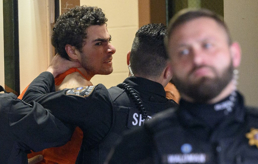 Luigi Mangione is led into the Blair County Courthouse for an extradition hearing December 10, 2024 in Hollidaysburg, Pennsylvania, US. Mangione has been arraigned on weapons and false identification charges related to the fatal shooting of United Healthcare CEO Brian Thompson in New York City. Mangione is incarcerated in the State Correctional Institution in Huntingdon, Pennsylvania awaiting extradition to New York. 
