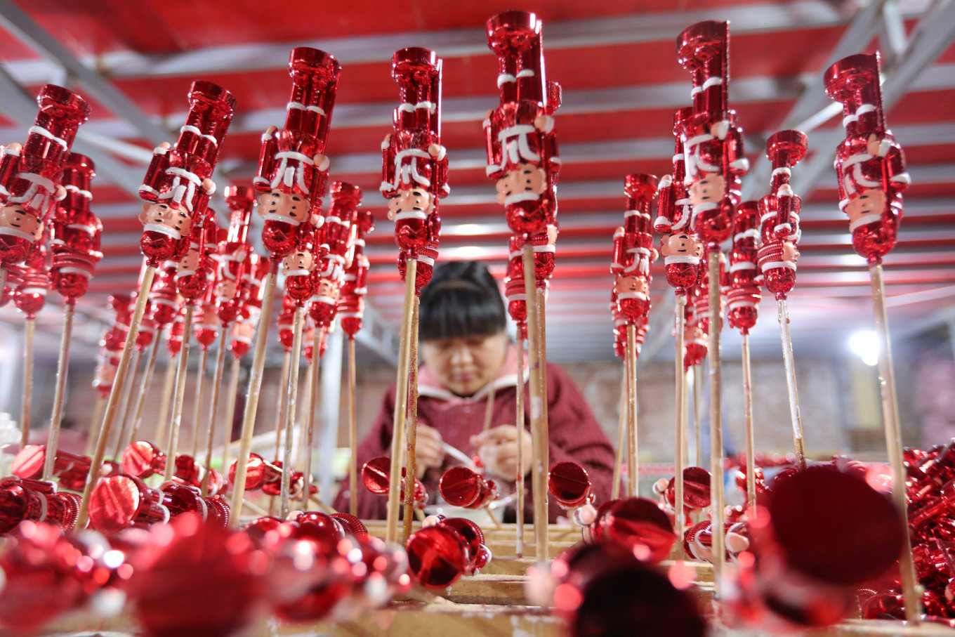 Year-end economy: A worker makes Christmas decorations at a workshop in Huaibei, in China's eastern Anhui Province on Dec. 10.