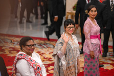 Second Deputy Higher Education, Science and Technology Minister Stella Christie (center) waves as she stands next to Deputy Tourism Minister Ni Luh Enik Ernawati (right) and Second Deputy Home Minister Ribka Haluk (left) during the inauguration of deputy ministers for Prabowo's Red and White Cabinet at the State Palace in Jakarta on Oct. 21, 2024. President Prabowo Subianto inaugurated 56 deputy ministers on that day for the 2024-2029 period. 