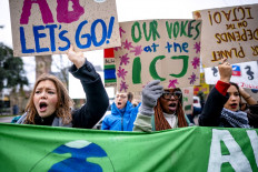 Voices for Earth: A group of climate activists demonstrate in front of the International Court of Justice (ICJ) in The Hague, the Netherlands, for climate justice on Dec. 2, 2024. For the first time, a major climate case has begun at the court to determine what legal obligations countries have to protect the climate.