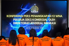 To be deported: Several female Vietnamese nationals who were arrested for their alleged involvement in a prostitution ring in North Jakarta are presented during a press briefing in Jakarta on Dec. 13. The immigration office has arrested 12 Vietnamese women for the alleged misuse of their tourist visas to offer sexual services in Muara Karang, North Jakarta.