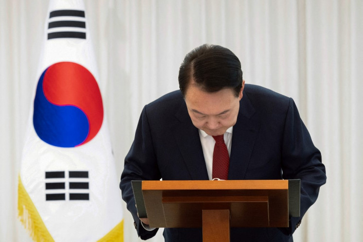 South Korean President Yoon Suk Yeol bows during a public address from his official residence in Seoul in this handout photo issued by the South Korean Presidential Office via Yonhap on Dec. 14, 2024. Yoon on Dec. 14 said he would “step aside“ after parliament voted to remove him from office, urging an end to “politics of excess and confrontation“. South Korean lawmakers on Saturday impeached Yoon over his failed martial law bid, with the opposition declaring a “victory of the people“.