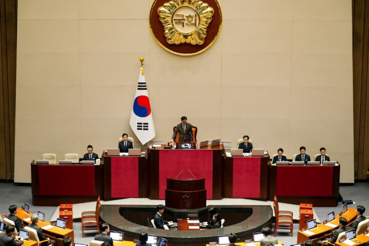 South Korean National Assembly Speaker Woo Won-shik (center) bangs the gavel to initiate the plenary session for the impeachment vote of President Yoon Suk Yeol at the National Assembly in Seoul on Dec. 14, 2024. South Korean lawmakers on Dec. 14 voted to remove President Yoon Suk Yeol from office for his failed attempt to impose martial law last week.