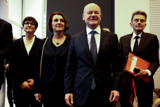 German Chancellor Olaf Scholz walks with his wife Britta Ernst to attend a parliamentary group meeting of the Social Democratic Party of Germany (SPD), on the day of a confidence vote called by Scholz to pave way for snap election, in Berlin, Germany, on Monday, December 16, 2024. 