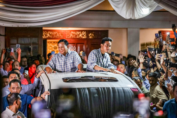Then-candidate Prabowo Subianto and his running mate, Gibran Rakabuming Raka, greet supporters in Jakarta on Feb. 14 after claiming victory in the first round of Indonesia’s presidential election.