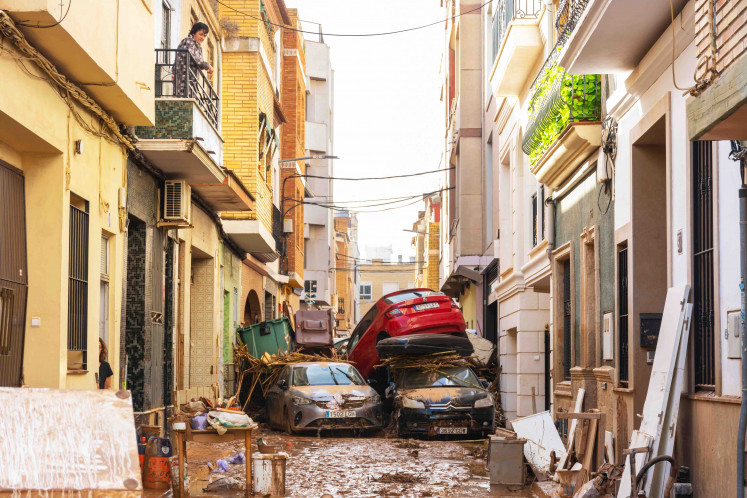 Cars are piled up after being swept away by catastrophic floods in Valencia, Spain, on Oct. 31.