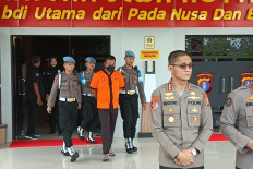 Demand for accountability: Central Kalimantan Police Internal Affairs officers escort Palangka Raya City Police officer Brig. AK (third left) to attend a press conference at the provincial police headquarters in Palangka Raya, Central Kalimantan, on Dec. 16, 2024. The police officer was dishonorably discharged from the police force for his alleged involvement in a murder case. 