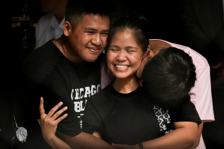 Philippine drug convict and former death row inmate Mary Jane Veloso is kissed by her sons at the Correctional Institution for Women in Mandaluyong City, Metro Manila, the Philippines, on Dec. 18, 2024. 