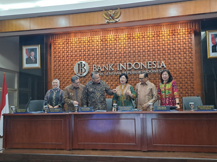 Bank Indonesia's (BI) Board of Governors members pose for a photo on Dec. 18, 2024, before a monthly press conference held at the central bank's Jakarta headquarters.