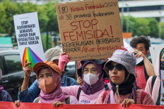 Activists hold banners during a peaceful demonstration against gender-based violence in Jakarta on Nov. 25, 2024. The protesters urged the government to justly resolve cases of gender-based violence and to improve women’s safety.