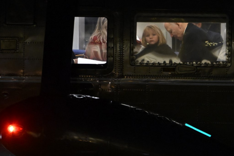 United States President Joe Biden and his grandson Beau Biden are seen on board Marine One as they return to the South lawn of the White House in Washington, DC, on Dec. 19, 2024.