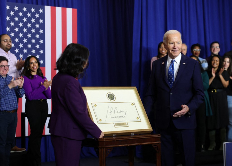 United States President Joe Biden (right) is induced to the Department of Labor Hall of Honor by Acting Secretary of Labor Julie Su during a ceremony at the Department of Labor on Dec. 16, 2024 in Washington, DC. Biden signed a proclamation to establish the Frances Perkins National Monument in Maine, dedicated to Perkins who was the first female Cabinet secretary and served as the Labor Secretary under Franklin D. Roosevelt.