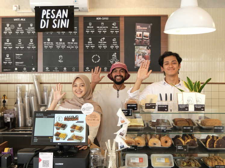 Daily dose: Baristas of Jakarta-based coffee chain Tuku pose for a photo in one of the young company’s outlets.