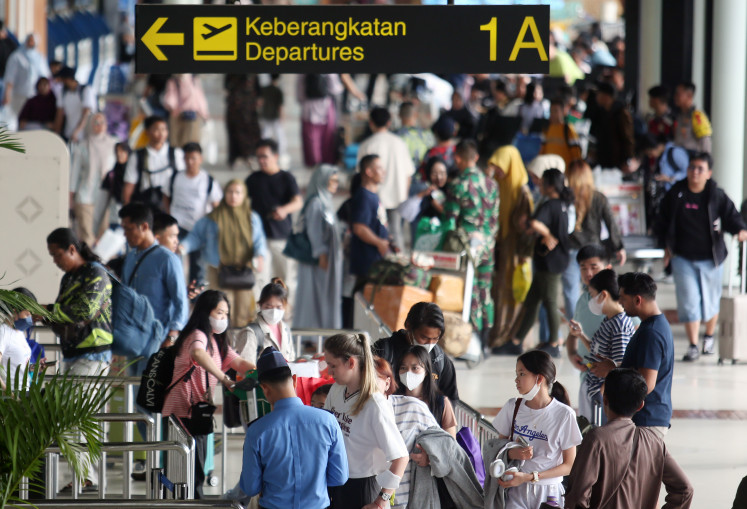 Prospective airplane passengers queue to enter terminal 1A of Soekarno Hatta Airport on Dec. 21, 2024, in Tangerang, Banten. 