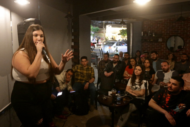 Mary Obaid performs during a comedy night titled “Styria“ which is an Arabic mash-up of Syria and hysteria in Damascus on April 24, 2023. Every week, members of Syria's first stand-up comedy troupe crack jokes about daily struggles like power cuts and fuel shortages, lightening the mood for despondent Damascenes after 12 years of war.