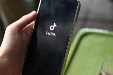 The logo of the social media platform TikTok is displayed on a mobile phone in Hanoi on October 6, 2023. New Vietnamese internet rules requiring Facebook and TikTok to verify user identities and hand over data to authorities came into force on December 25, 2024 in what critics say is the latest attack on freedom of expression.