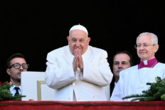 Pope Francis greets the crowd from the main balcony of St. Peter's Basilica after the Urbi et Orbi message and blessing to the city and the world as part of Christmas celebrations at St Peter's square in the Vatican on Dec. 25, 2024.