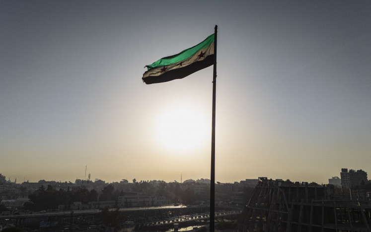 The Syrian independence flag waves on Dec. 26, 2024, in Damascus.