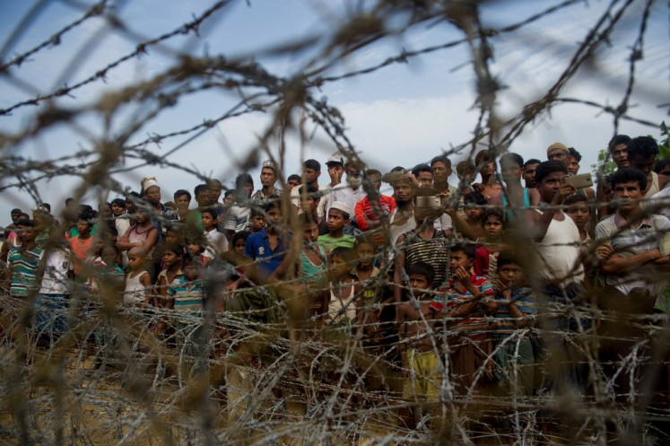 Rohingya refugees gather in the “no man's land“ behind Myanmar's border lined with barbed wire fences in Maungdaw district, Rakhine state bounded by Bangladesh on April 25, 2018.